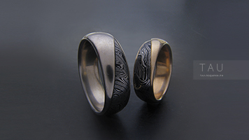 Двухцветные обручальные кольца из золота и стали.